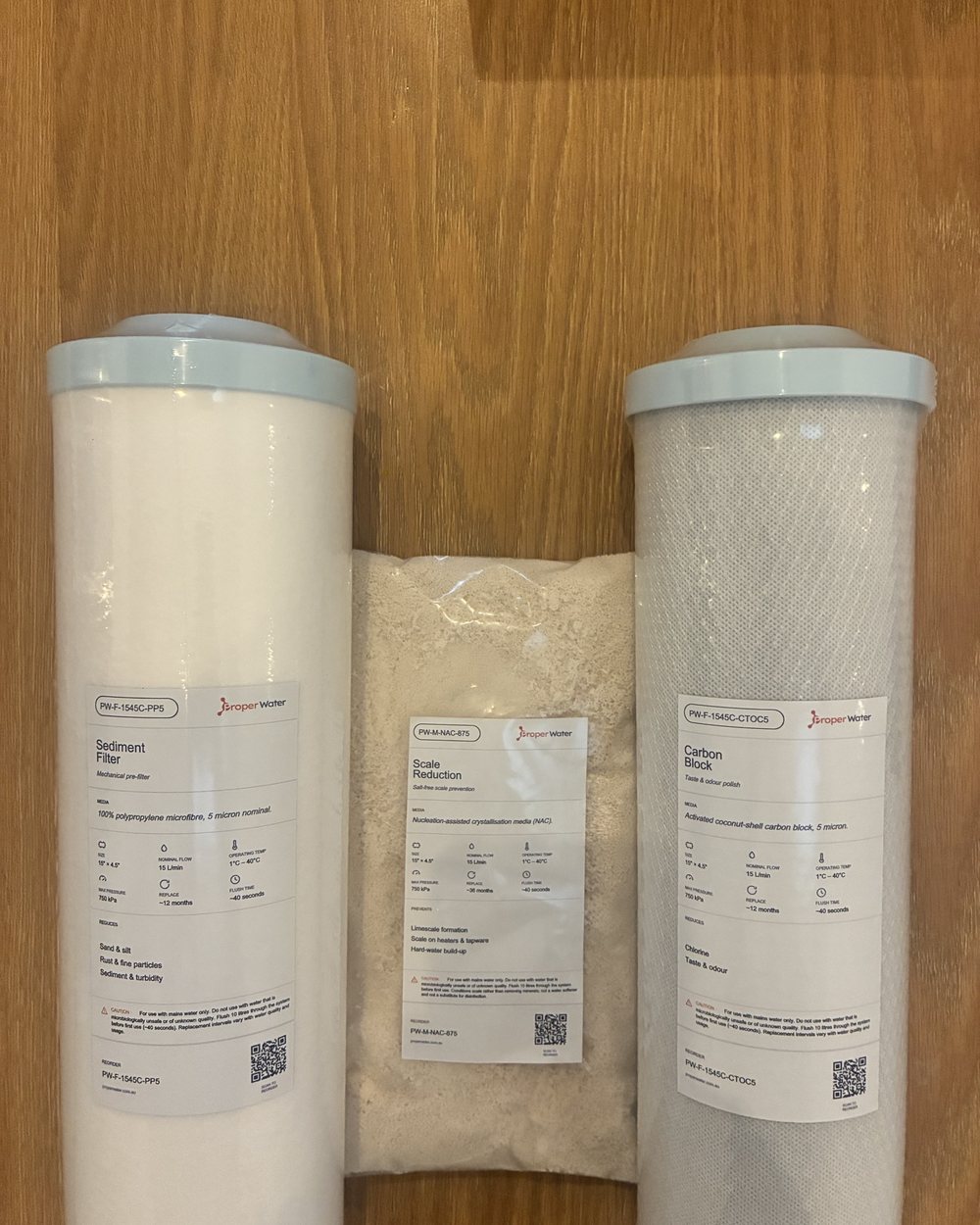 Complete Home Filtration compatible NAC set standing on a table, sediment, carbon block and salt-free NAC media