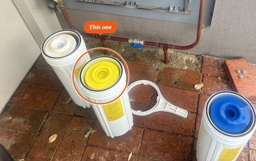 Complete Home Filtration system opened: white, yellow and blue cartridges, the yellow resin cartridge marked
